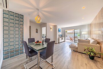 A living room with a dining table and chairs