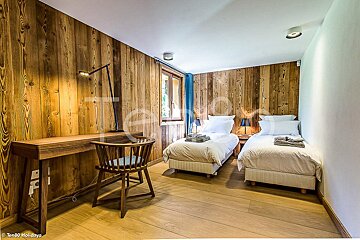 A bedroom with two beds and a desk with the word holidays on it