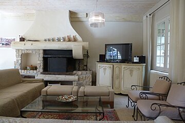 A living room with a fireplace and a flat screen tv