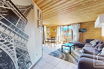 A living room with a picture of the eiffel tower on the wall