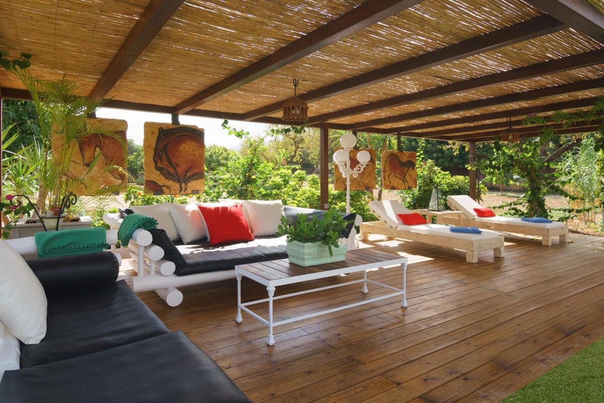 A wooden deck with a couch and a table