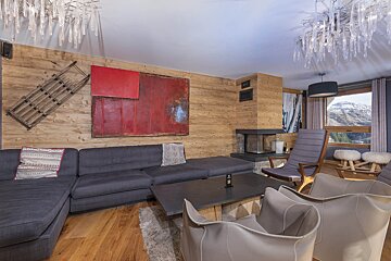 A living room with a couch and chairs and a fireplace