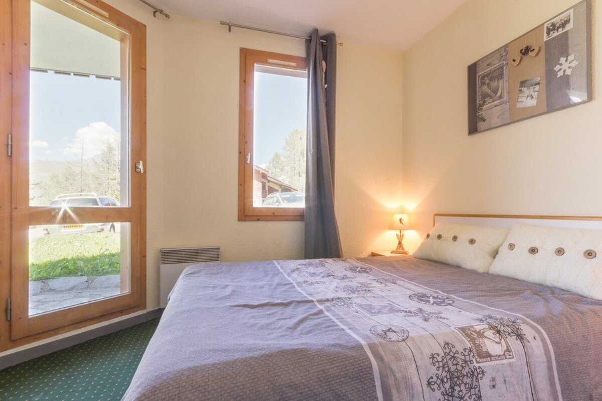 A bedroom with a large bed and a window