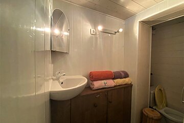 A bathroom with a sink and towels on the counter