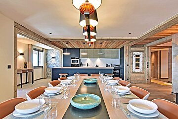 A dining room table with plates and bowls on it