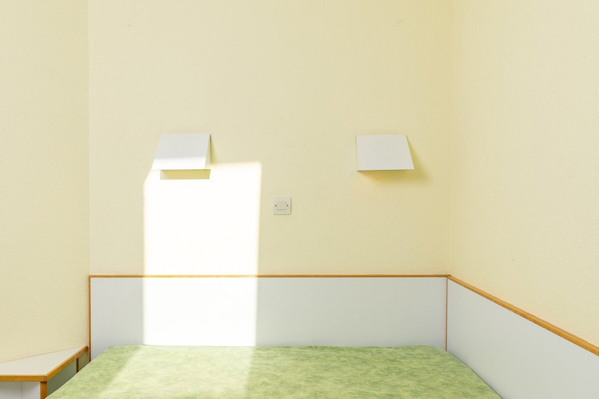 A bathroom with a yellow sink and white tiles