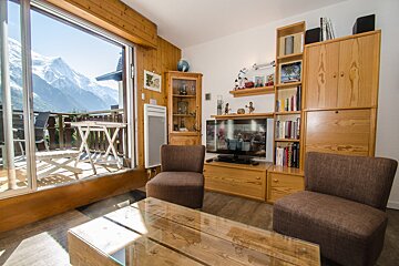 A living room with two chairs and a flat screen tv