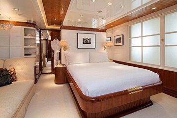 A bedroom with a large bed and a couch