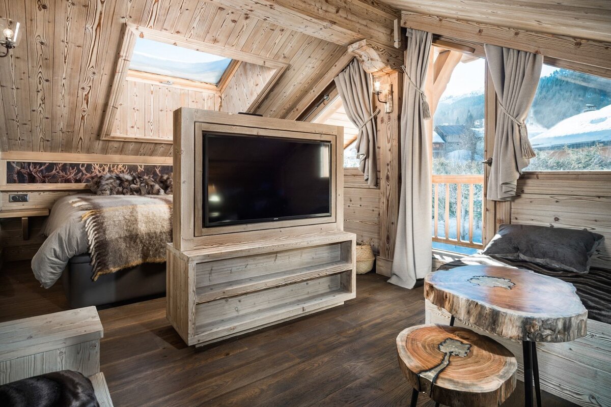 A wooden room with a large flat screen tv
