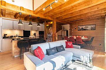 A living room with a couch and a dining table
