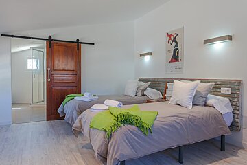 A bedroom with two beds and a poster on the wall