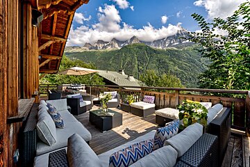 A wooden deck with a view of mountains