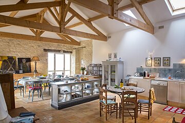 A kitchen and dining area with a table and chairs
