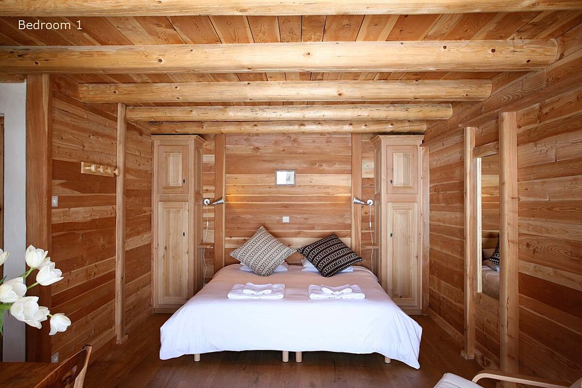 A bedroom with a bed and a sign that says bedroom 1