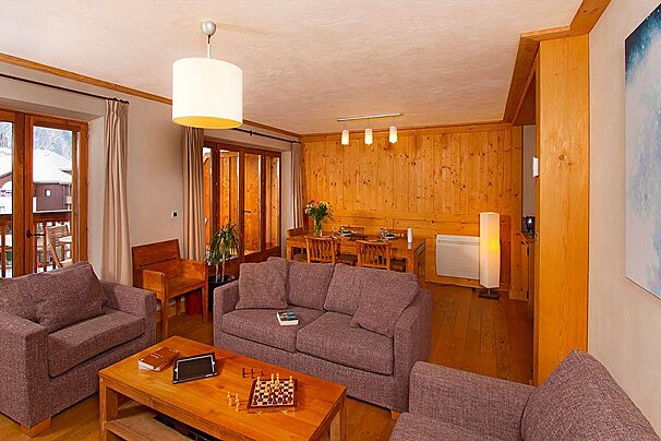 A living room with a couch a chair and a coffee table
