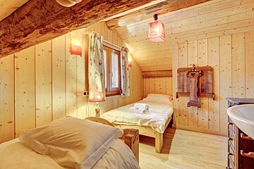 A bedroom with a single bed and a sink