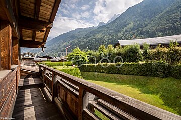 A balcony with a view of the mountains and a sign that says tango holidays