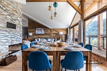 A living room with a blue couch and a globe on a table