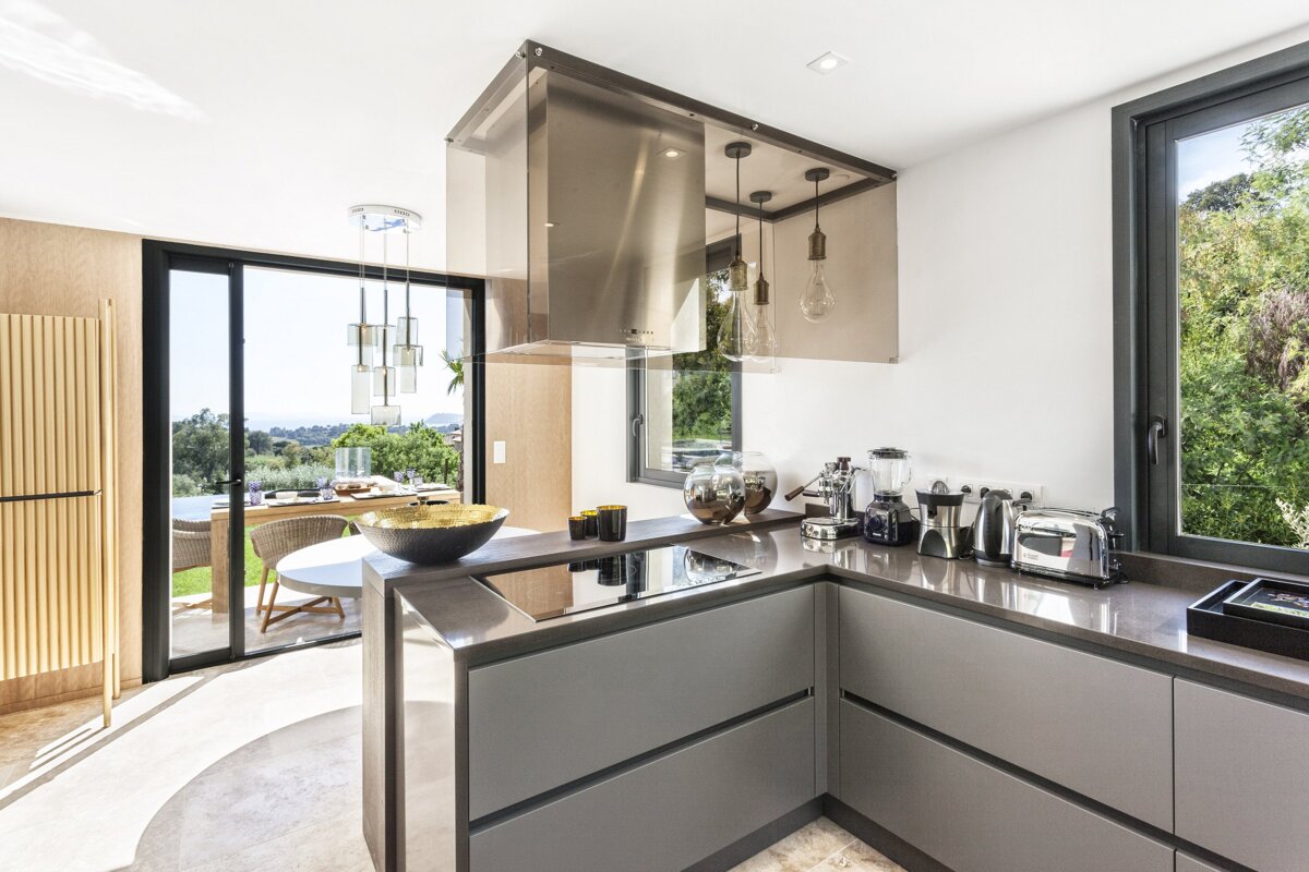 A kitchen with stainless steel appliances including a toaster oven