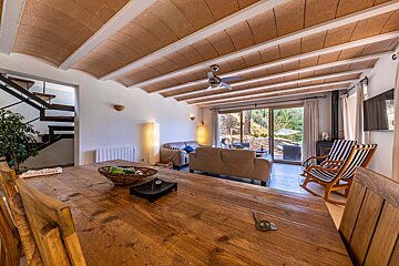 A living room with a wooden table and chairs