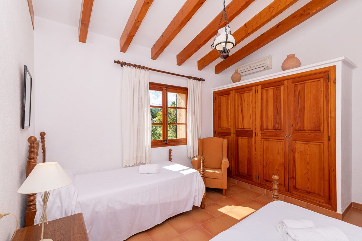 A bedroom with two beds and a large closet