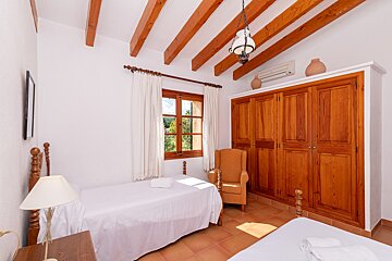 A bedroom with two beds and a large closet