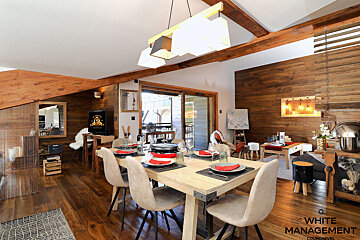 A dining room with a table and chairs and a sign that says rente designer