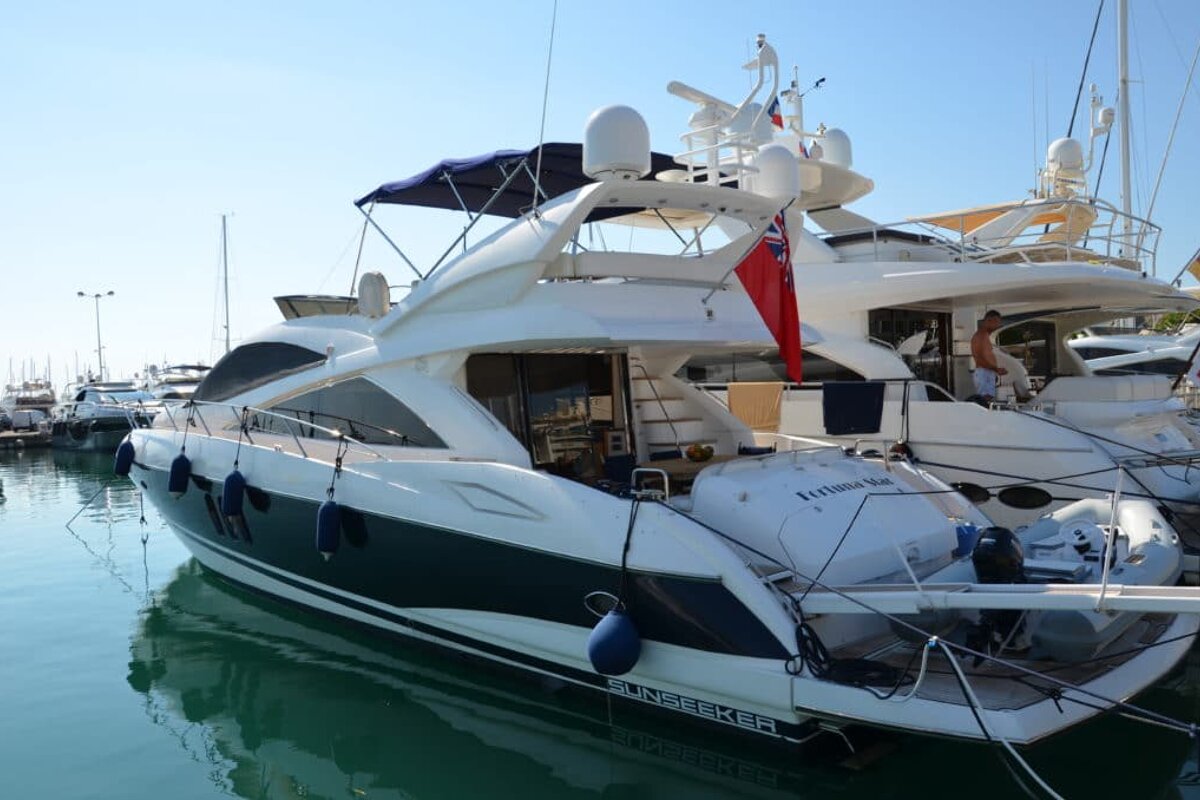 A sunseeker yacht is docked in a marina