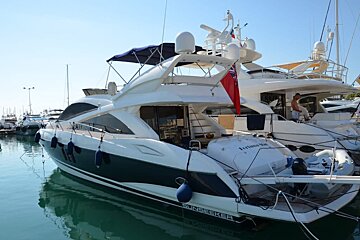 A sunseeker yacht is docked in a marina