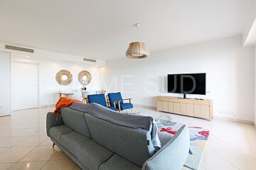 A living room with a couch and a television with the word mesud on the wall