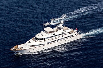 A large white yacht is floating in the ocean