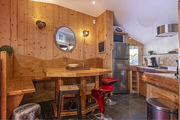 A kitchen with wood paneling and a lg refrigerator