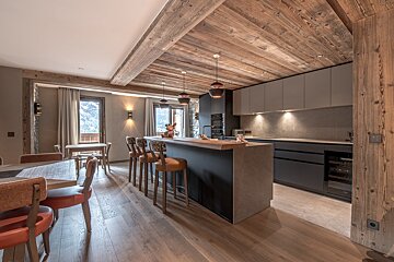 A kitchen with wooden cabinets and a large island