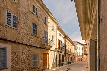 A row of buildings with shutters on the windows