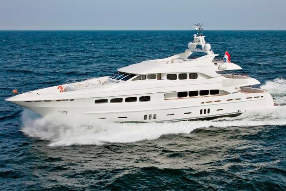 A large white yacht is floating in the ocean