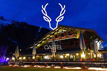 The chalet castel is lit up at night