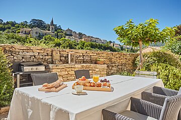 A table with a tray of food on it in front of a stone wall