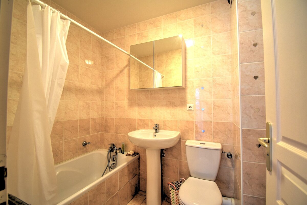 A bathroom with a sink toilet and bathtub