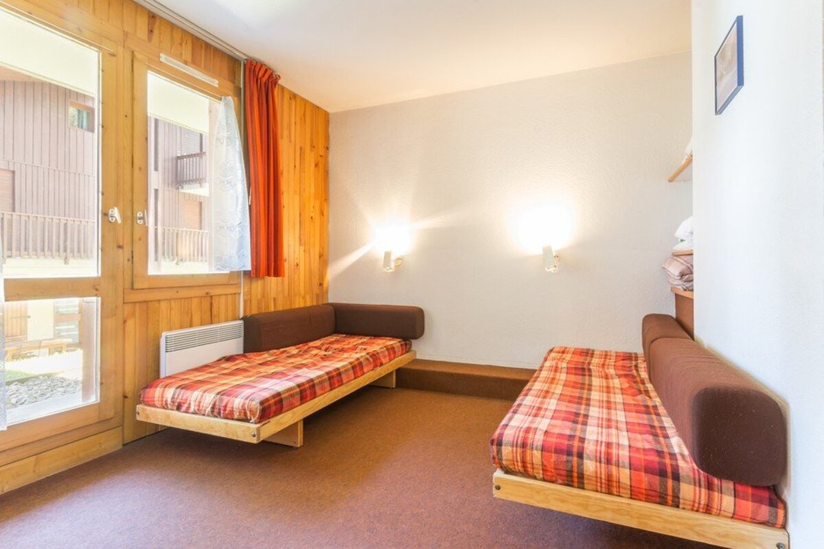 A room with two couches and a window