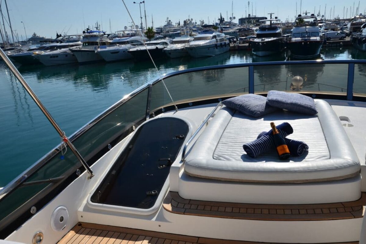 A bottle of champagne sits on the deck of a boat