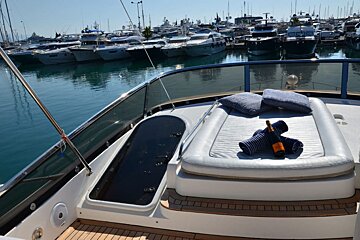 A bottle of champagne sits on the deck of a boat