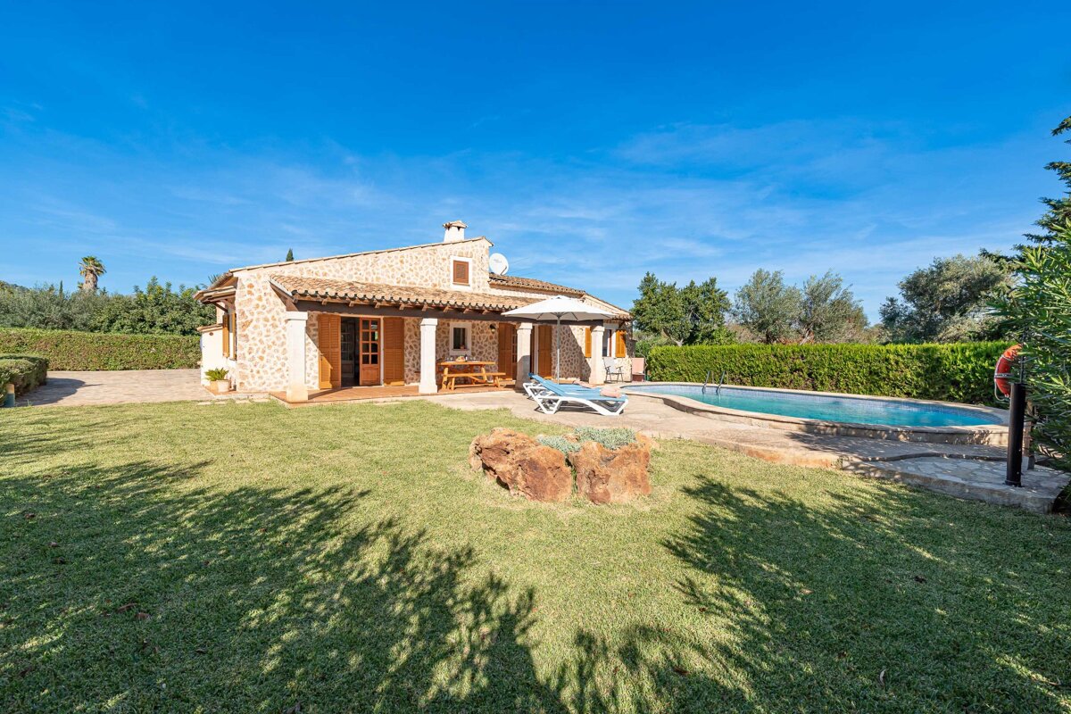 A house with a swimming pool in front of it