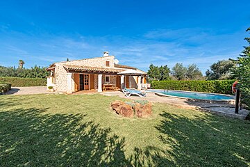 A house with a swimming pool in front of it