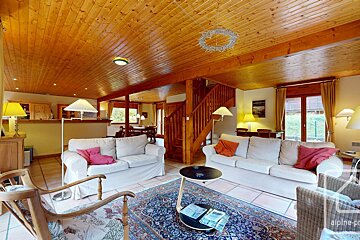 A living room with a couch and a rug and a sign that says alpine-prop