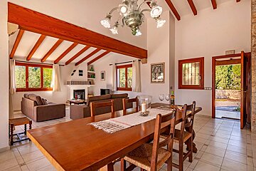 A living room with a dining table and chairs
