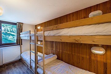 A bedroom with bunk beds and a window