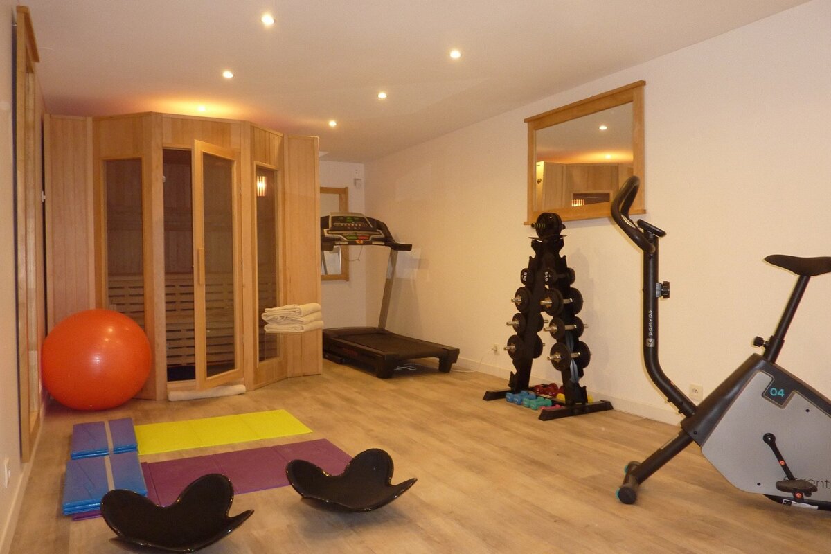 A gym with a treadmill and an exercise bike