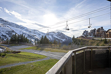 A view of a ski lift going up a mountain