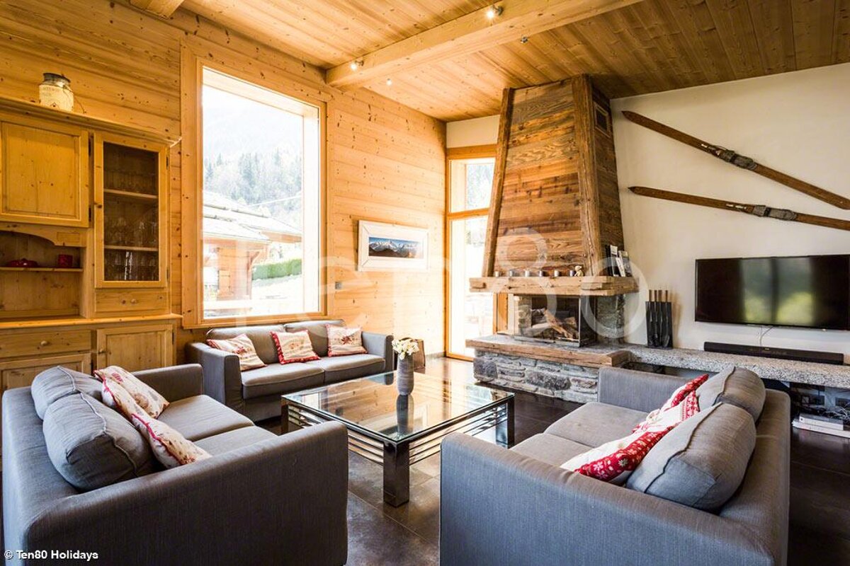 A living room with a fireplace and a flat screen tv