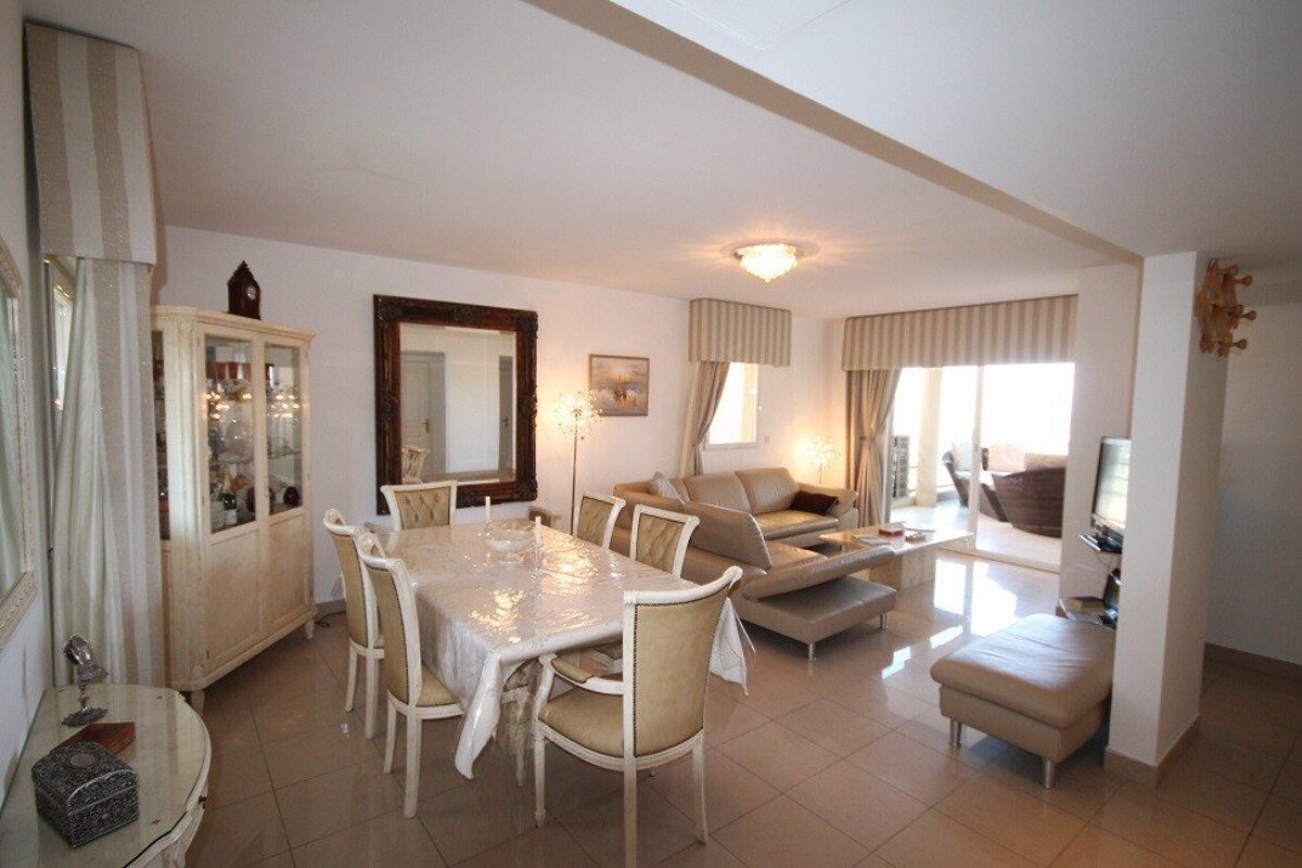 A living room with a dining table and chairs